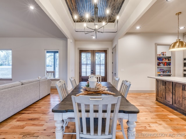 dining area featuring a chandelier, recessed lighting, baseboards, french doors, and light wood-type flooring