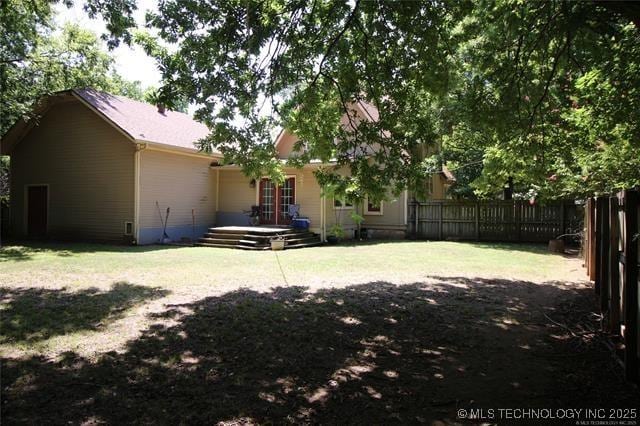 exterior space featuring fence and a yard