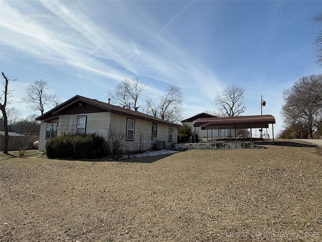 exterior space with a carport and central AC