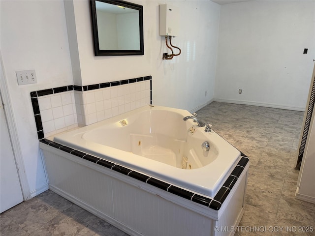 bathroom with baseboards, a whirlpool tub, and water heater