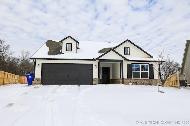 modern inspired farmhouse with a garage, brick siding, central AC unit, and fence