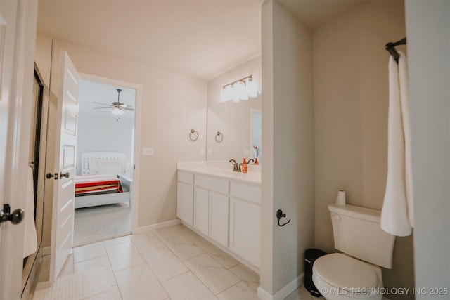 full bath featuring baseboards, connected bathroom, toilet, marble finish floor, and vanity