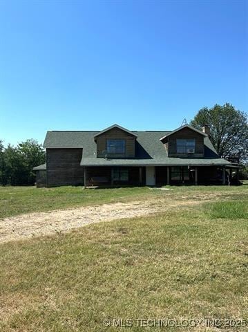 view of front of house featuring a front yard and a chimney