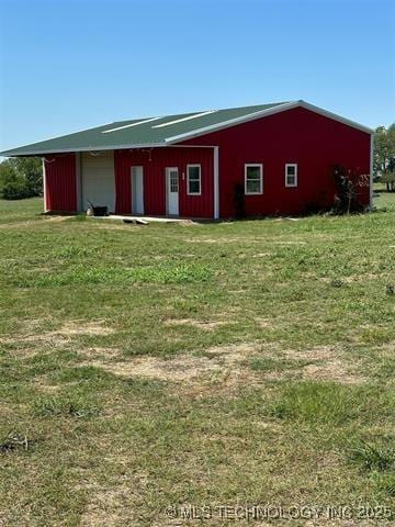 view of pole building with a lawn