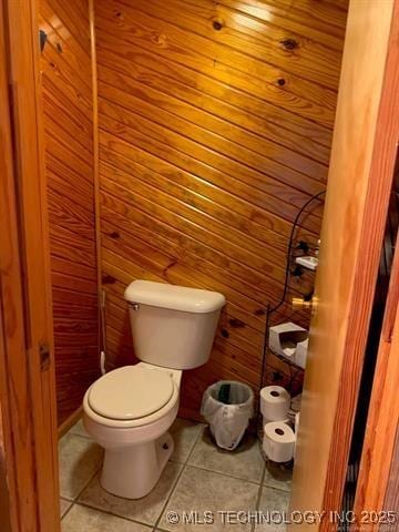 bathroom with toilet and tile patterned flooring