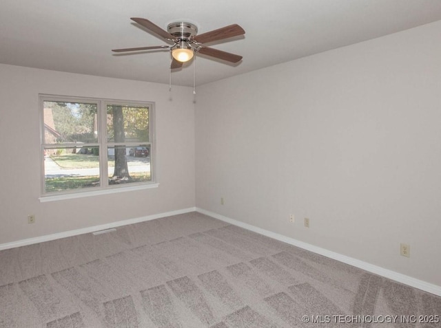 unfurnished room with carpet floors, ceiling fan, and baseboards