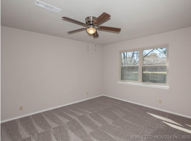 carpeted spare room with a ceiling fan, visible vents, and baseboards