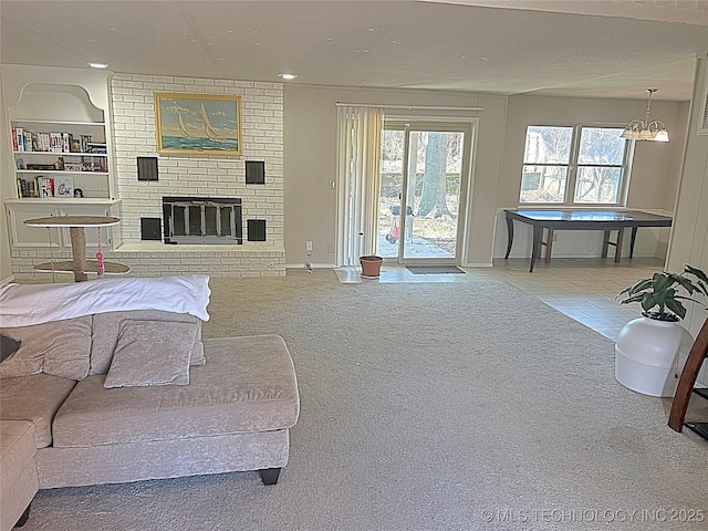 interior space featuring access to exterior, recessed lighting, a brick fireplace, and light colored carpet