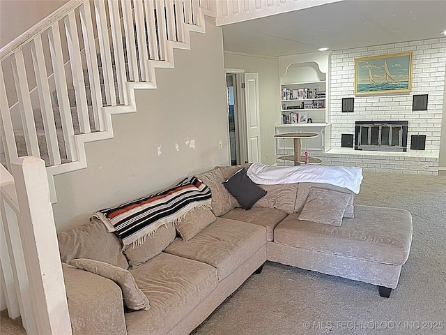 carpeted living room with built in shelves and a fireplace