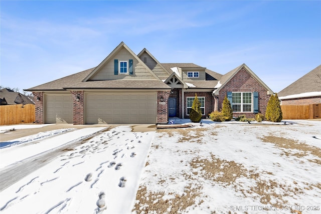 view of front of house featuring a garage, fence, and brick siding