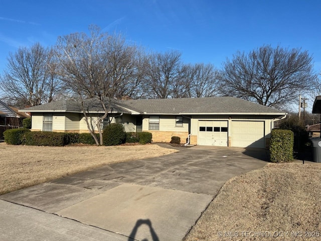 single story home with concrete driveway and a garage