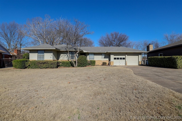 ranch-style home with driveway and an attached garage