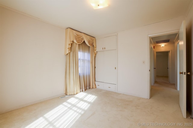unfurnished bedroom with light colored carpet, visible vents, and a closet