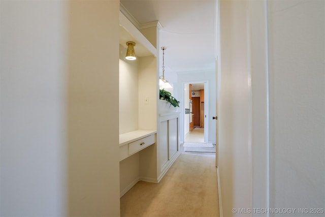 hall featuring light colored carpet