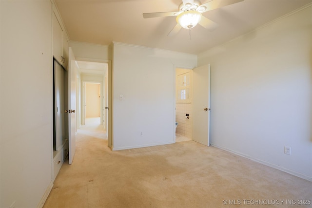 unfurnished bedroom with baseboards, ornamental molding, and light carpet