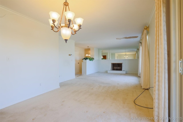 interior space with a chandelier, ornamental molding, carpet, and a fireplace