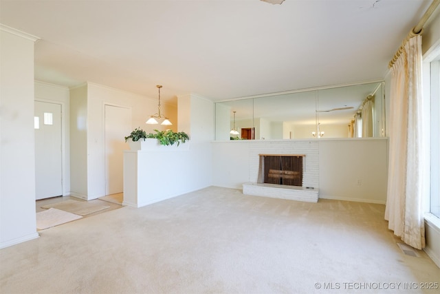 unfurnished living room with visible vents, ornamental molding, carpet flooring, and a brick fireplace