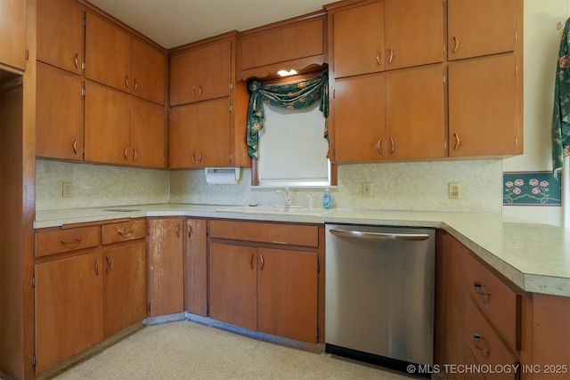 kitchen with light countertops, a sink, light floors, dishwasher, and decorative backsplash