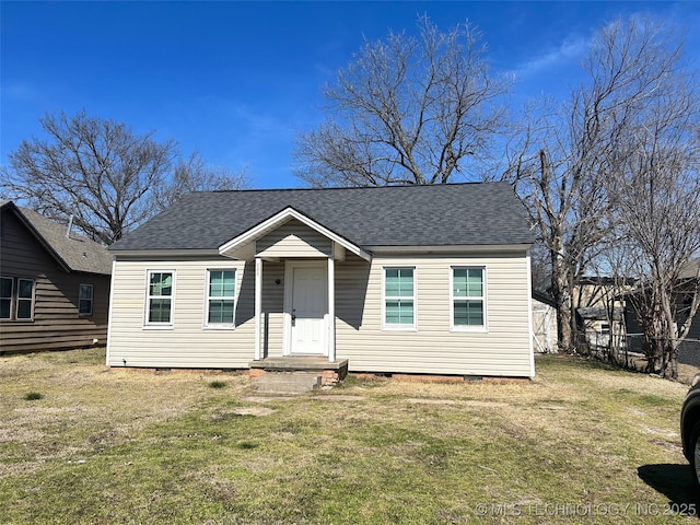 bungalow featuring a shingled roof, crawl space, and a front yard