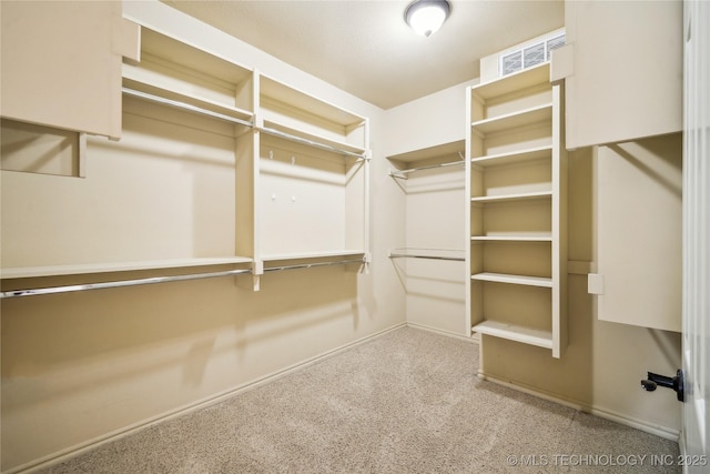 walk in closet featuring carpet floors and visible vents