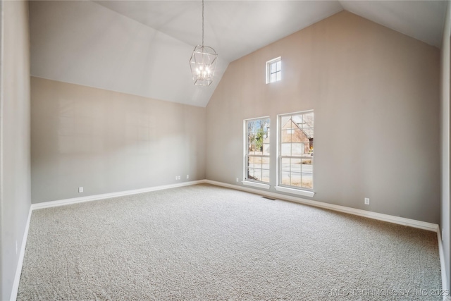 spare room featuring high vaulted ceiling, carpet, baseboards, and a notable chandelier