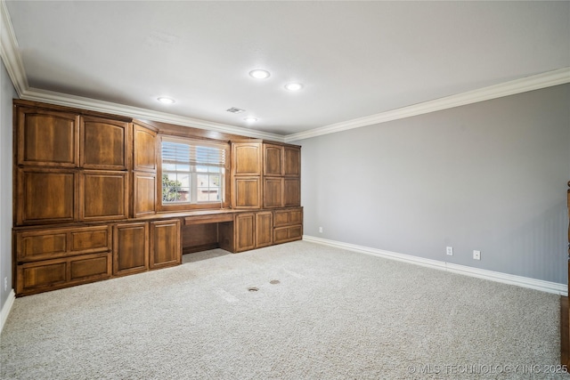 interior space featuring recessed lighting, carpet floors, baseboards, ornamental molding, and built in study area