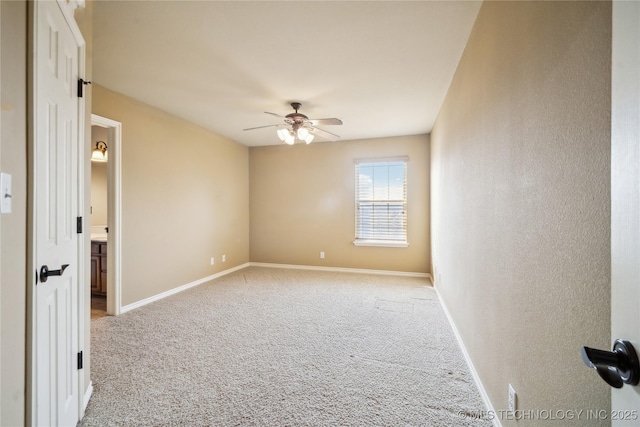 unfurnished room with baseboards, a ceiling fan, and light colored carpet