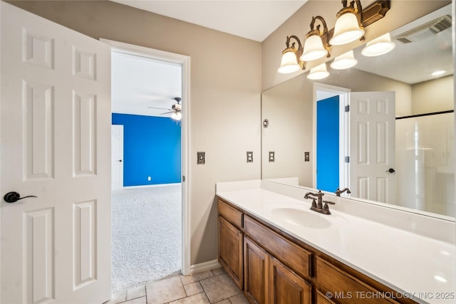 bathroom with ceiling fan, vanity, visible vents, baseboards, and a shower