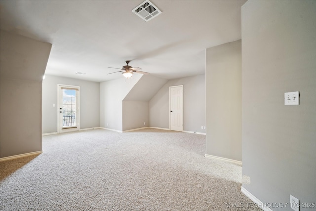 bonus room featuring baseboards, a ceiling fan, visible vents, and light colored carpet