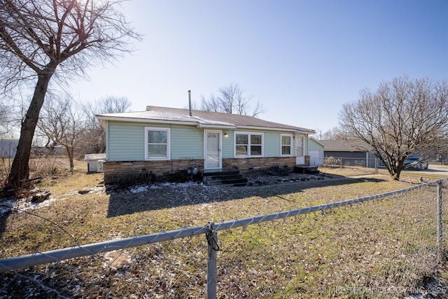 view of front of home featuring fence private yard and stone siding