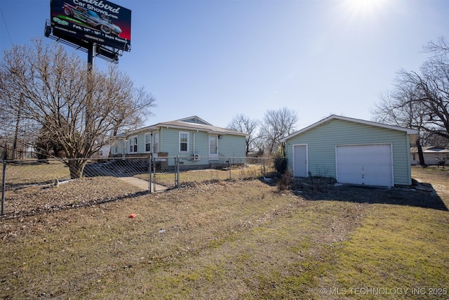 view of side of property featuring a garage, fence, an outbuilding, and a yard