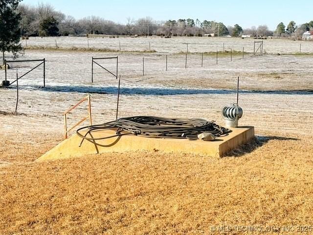 exterior space with a rural view and fence