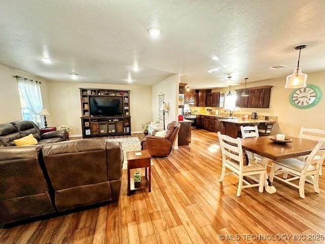 living area featuring light wood-type flooring and baseboards