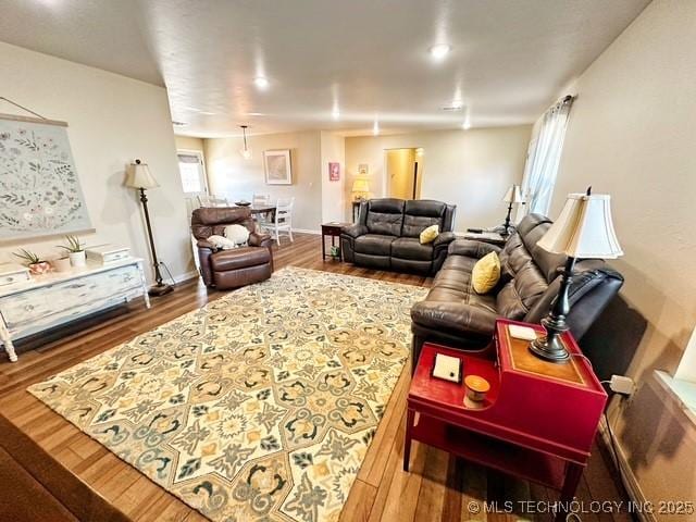 living room featuring baseboards and wood finished floors