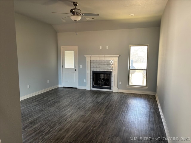 unfurnished living room featuring a fireplace, dark wood finished floors, a ceiling fan, and baseboards