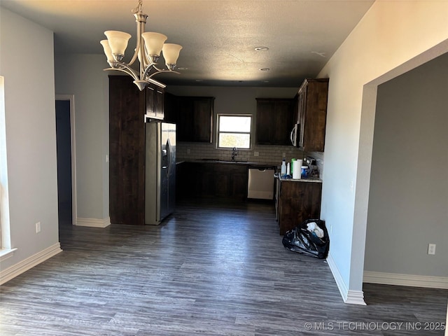 kitchen featuring decorative backsplash, appliances with stainless steel finishes, dark wood-type flooring, dark brown cabinets, and a sink