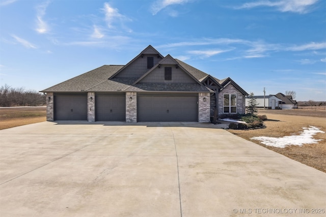 view of front facade featuring a garage, concrete driveway, and a shingled roof