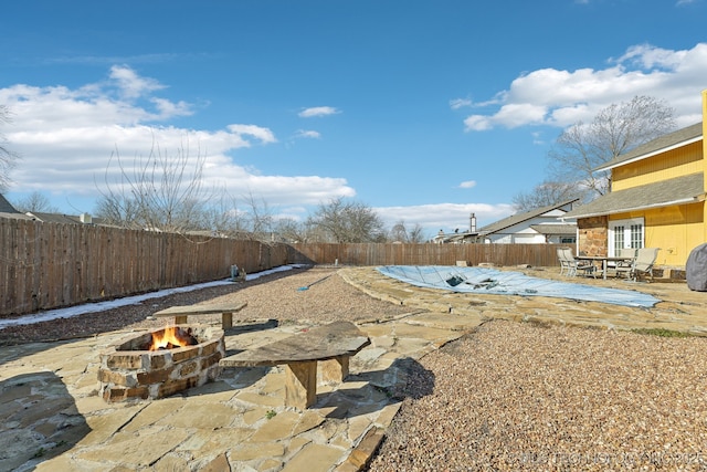 exterior space with an outdoor fire pit and a fenced backyard