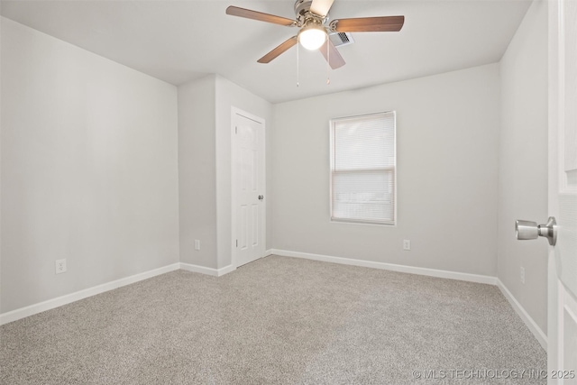 unfurnished room featuring light carpet, ceiling fan, visible vents, and baseboards