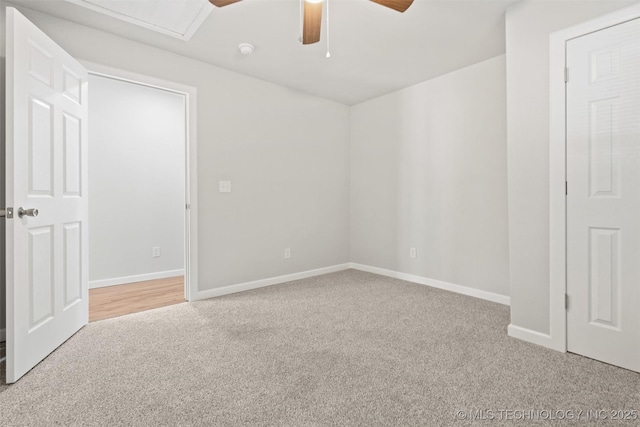 unfurnished room featuring a ceiling fan, carpet, and baseboards