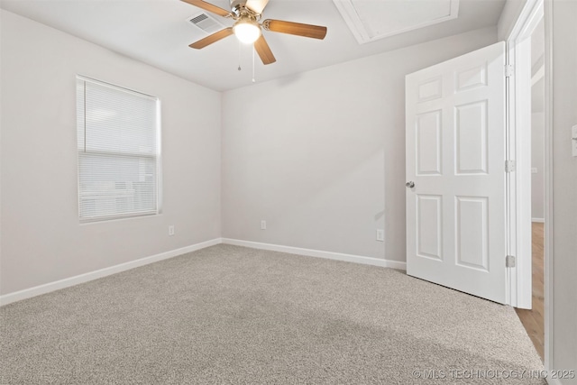 unfurnished room featuring light carpet, baseboards, visible vents, and a ceiling fan