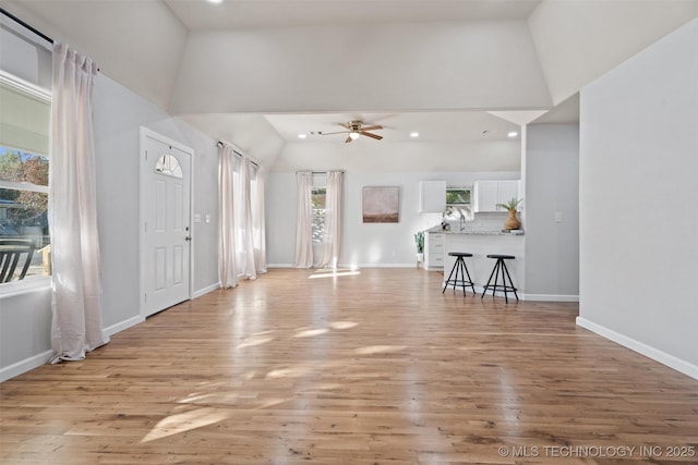 foyer featuring light wood finished floors, ceiling fan, baseboards, and recessed lighting