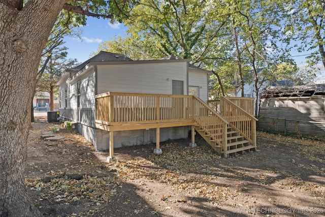 rear view of property with a deck, stairway, and central air condition unit