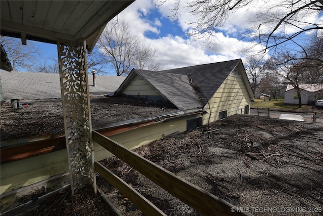 view of home's exterior with roof with shingles