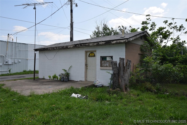 view of outbuilding featuring fence and an outdoor structure