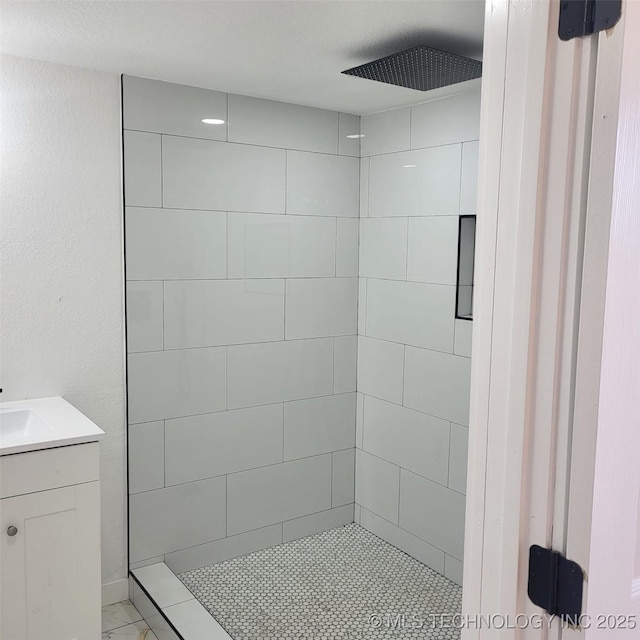 full bath with a shower stall and vanity