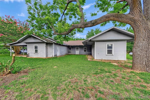 back of house featuring a yard