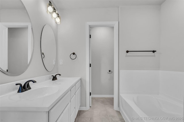 full bathroom with a bath, double vanity, baseboards, and a sink