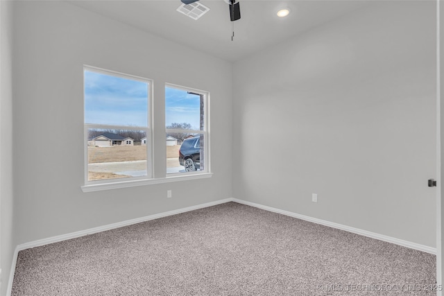 spare room featuring carpet, baseboards, visible vents, and ceiling fan