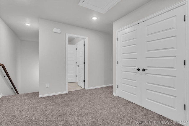 unfurnished bedroom featuring recessed lighting, a closet, light carpet, and baseboards